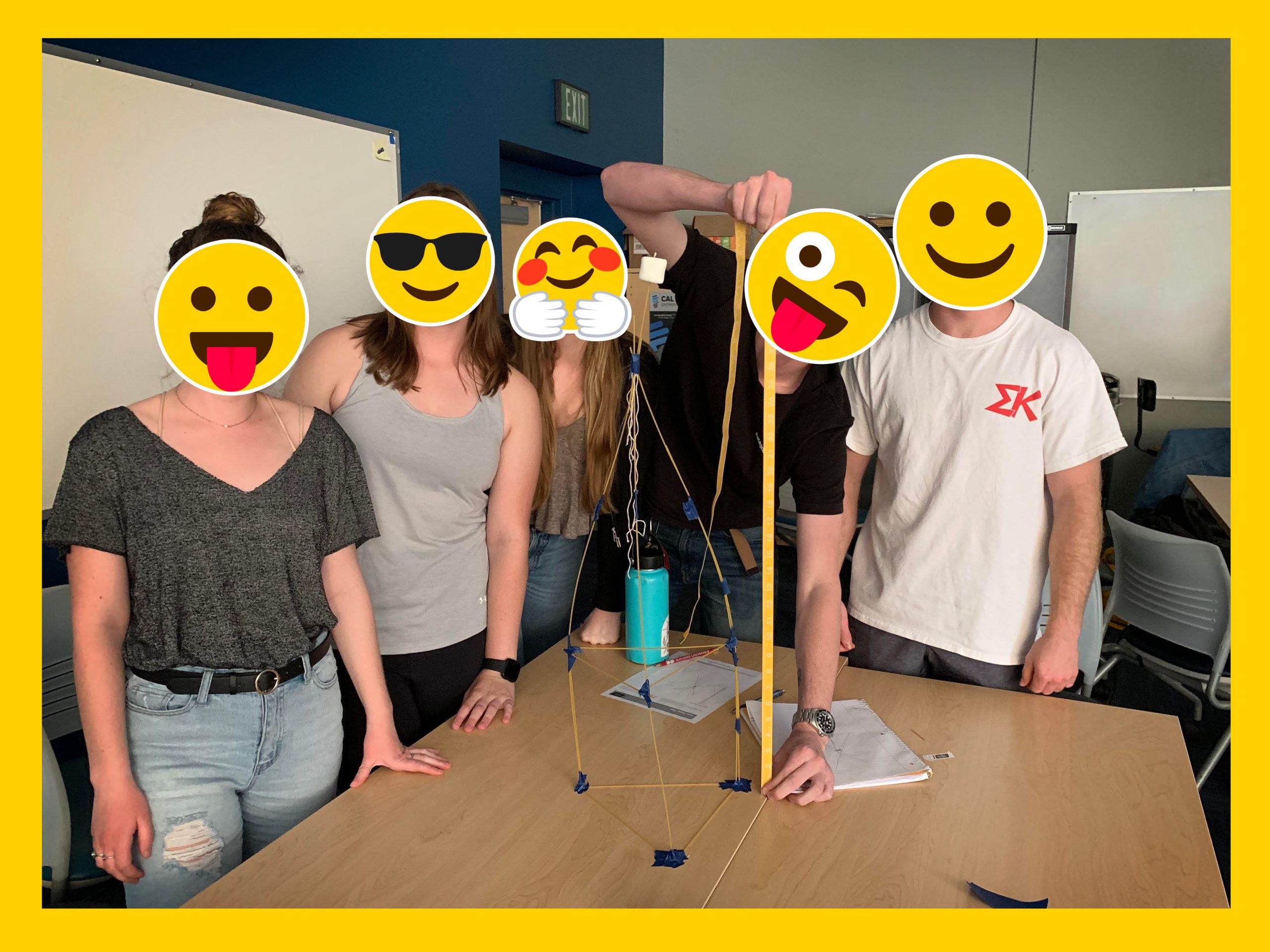Students completing the marshmallow challenge by building a tower with string spaghetti and tape free standing structure